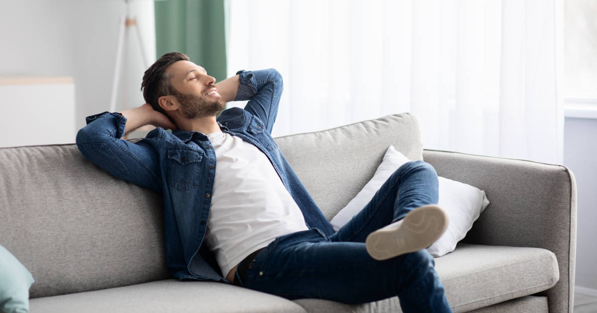 man relaxing on sofa